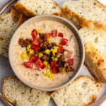 italian queso with sausage topped with tomaotes and peppers.
