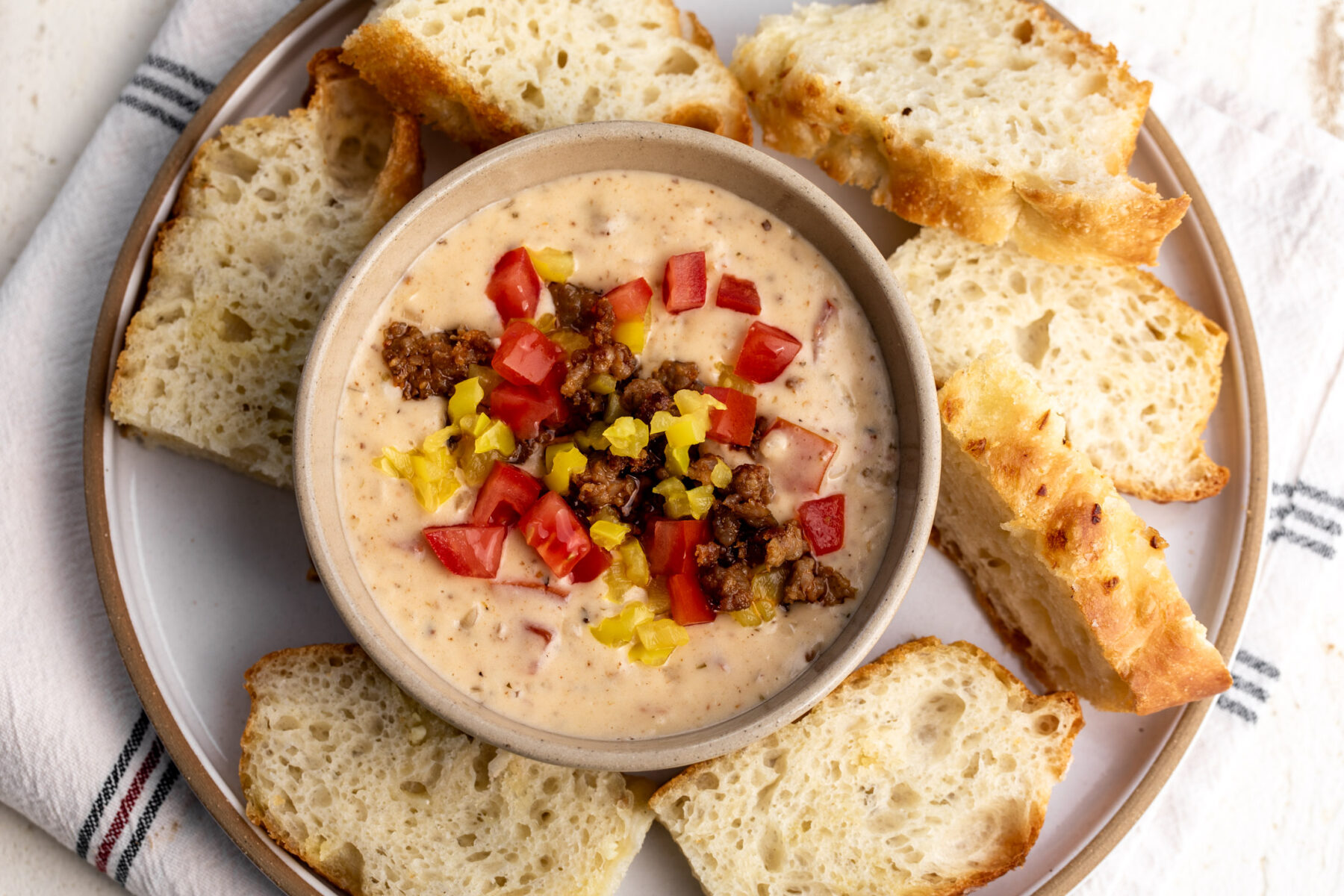 italian queso with sausage topped with tomaotes and peppers.