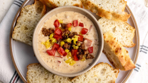 italian queso with sausage topped with tomaotes and peppers.