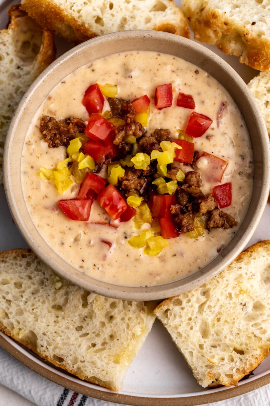 italian queso with sausage topped with tomaotes and peppers.