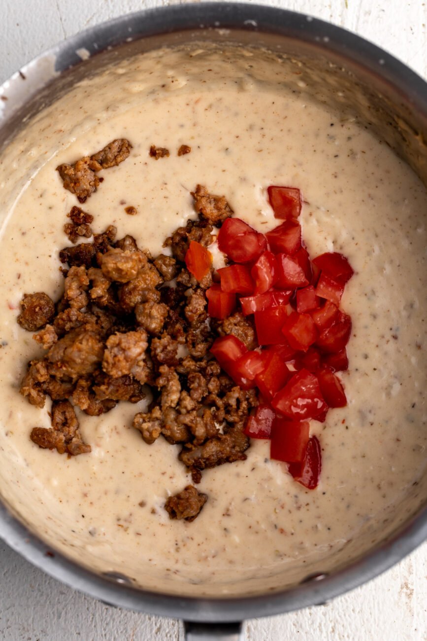 italian queso with sausage topped with tomaotes and peppers.