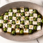 marinated green castelvetrano olives and feta cheese in checkerboard pattern.