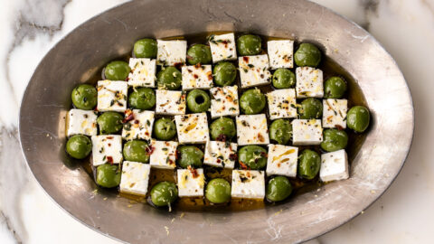 marinated green castelvetrano olives and feta cheese in checkerboard pattern.
