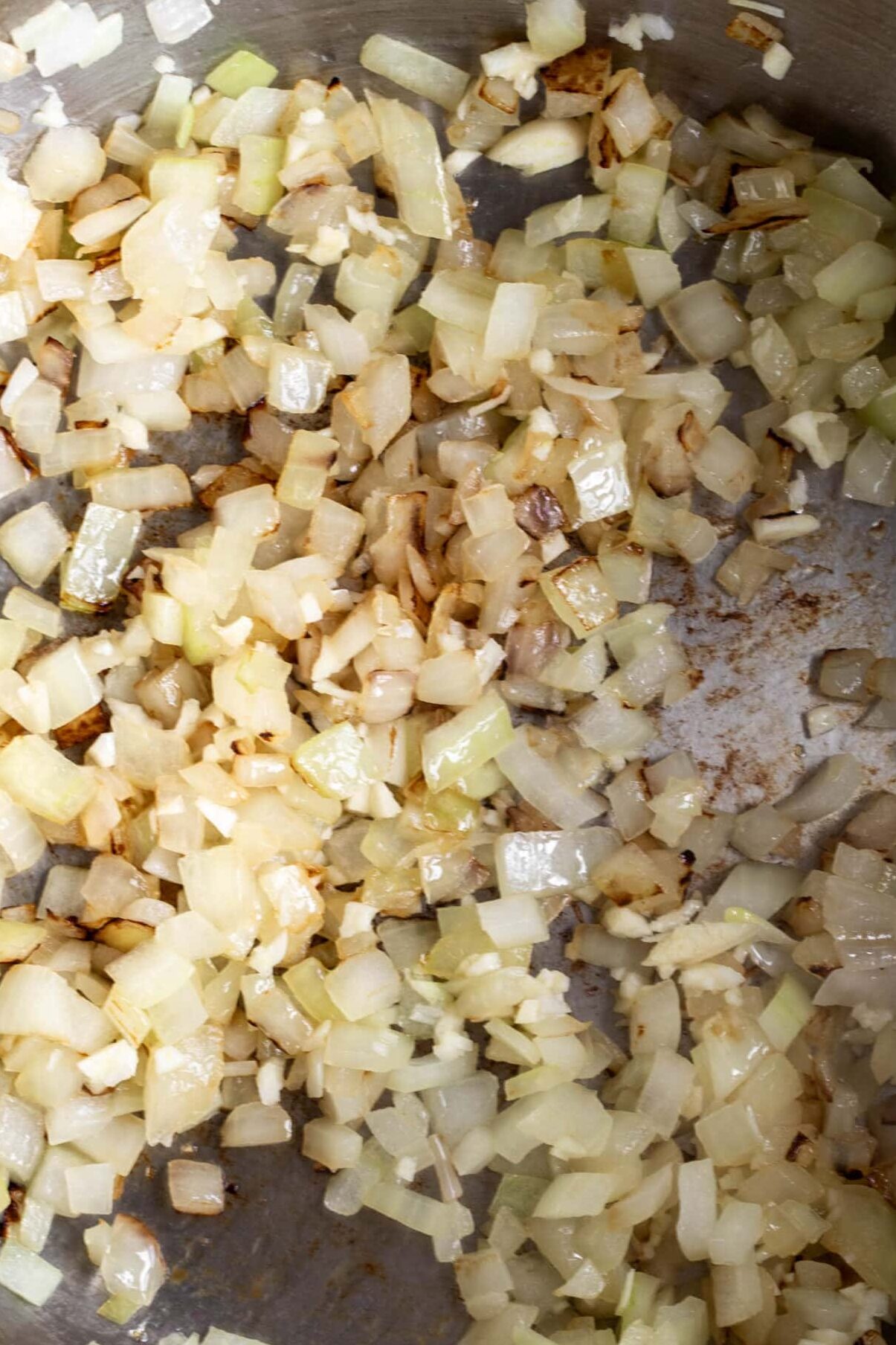 sautéed onions in pan creamy tomato cheddar soup base.