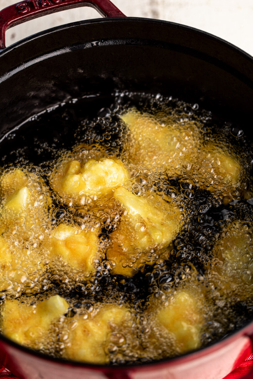 fried cauliflower florets in hot oil.