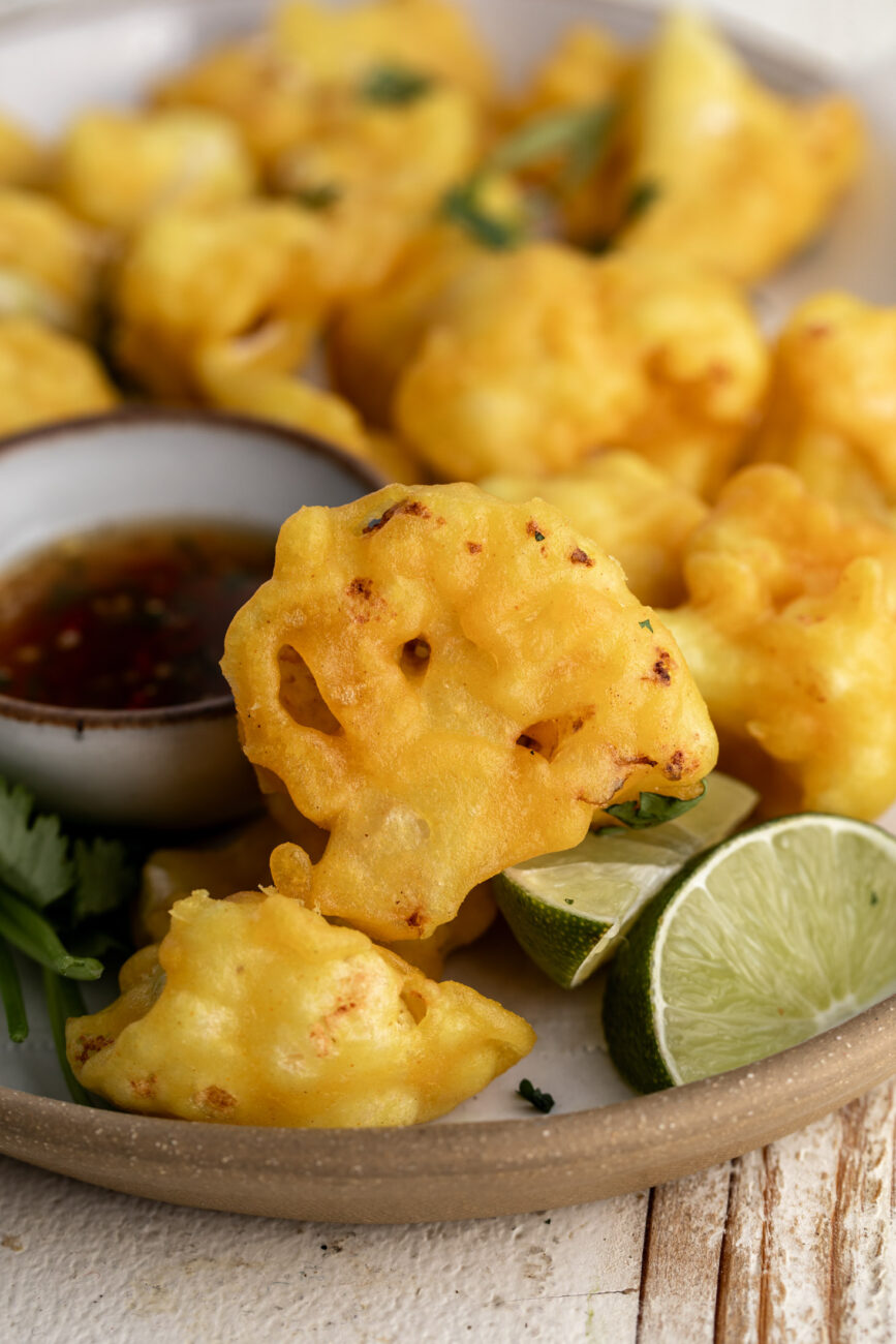 golden crispy fried cauliflower florets with lime.