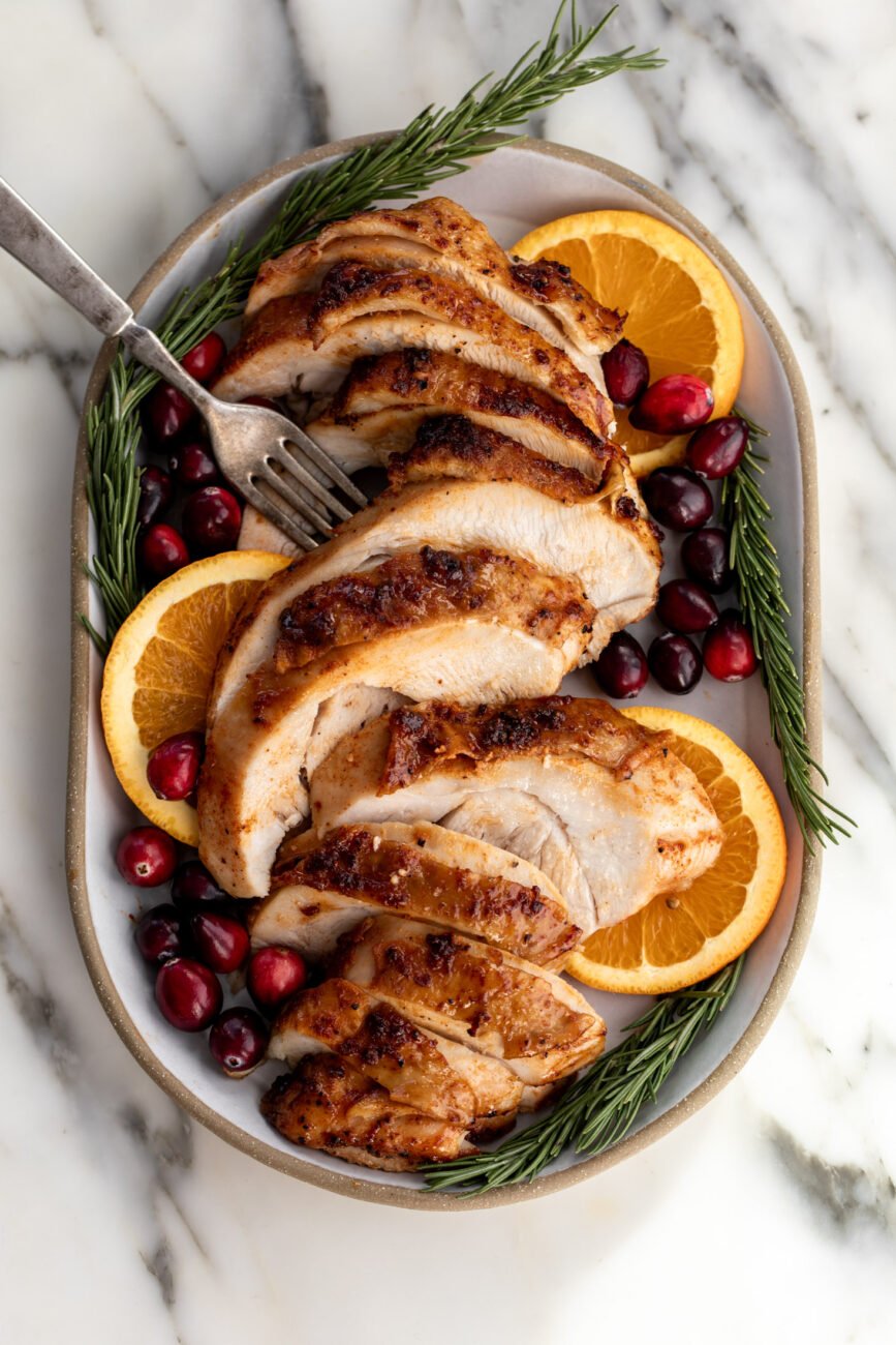 maple bourbon turkey breast garnished with oranges.