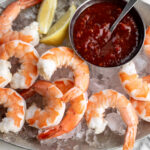 Shrimp Cocktail with Spicy Calabrian Chili Cocktail Sauce on platter with ice.