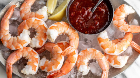 Shrimp Cocktail with Spicy Calabrian Chili Cocktail Sauce on platter with ice.