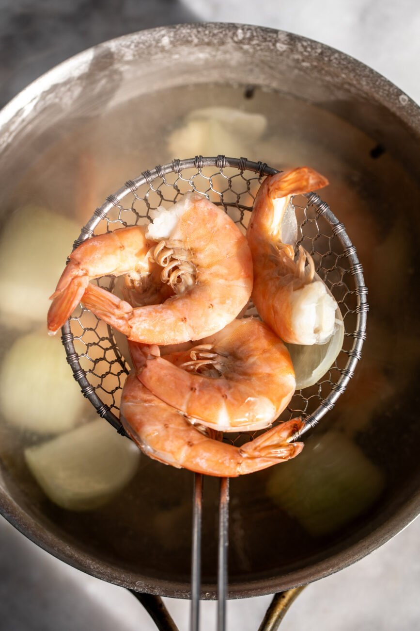 poached shrimp on mesh strainer.