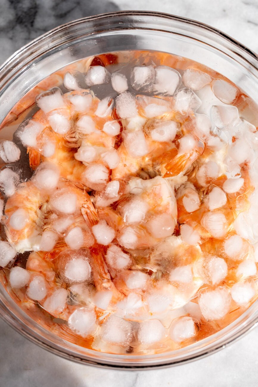 poached shrimp added to ice bath.