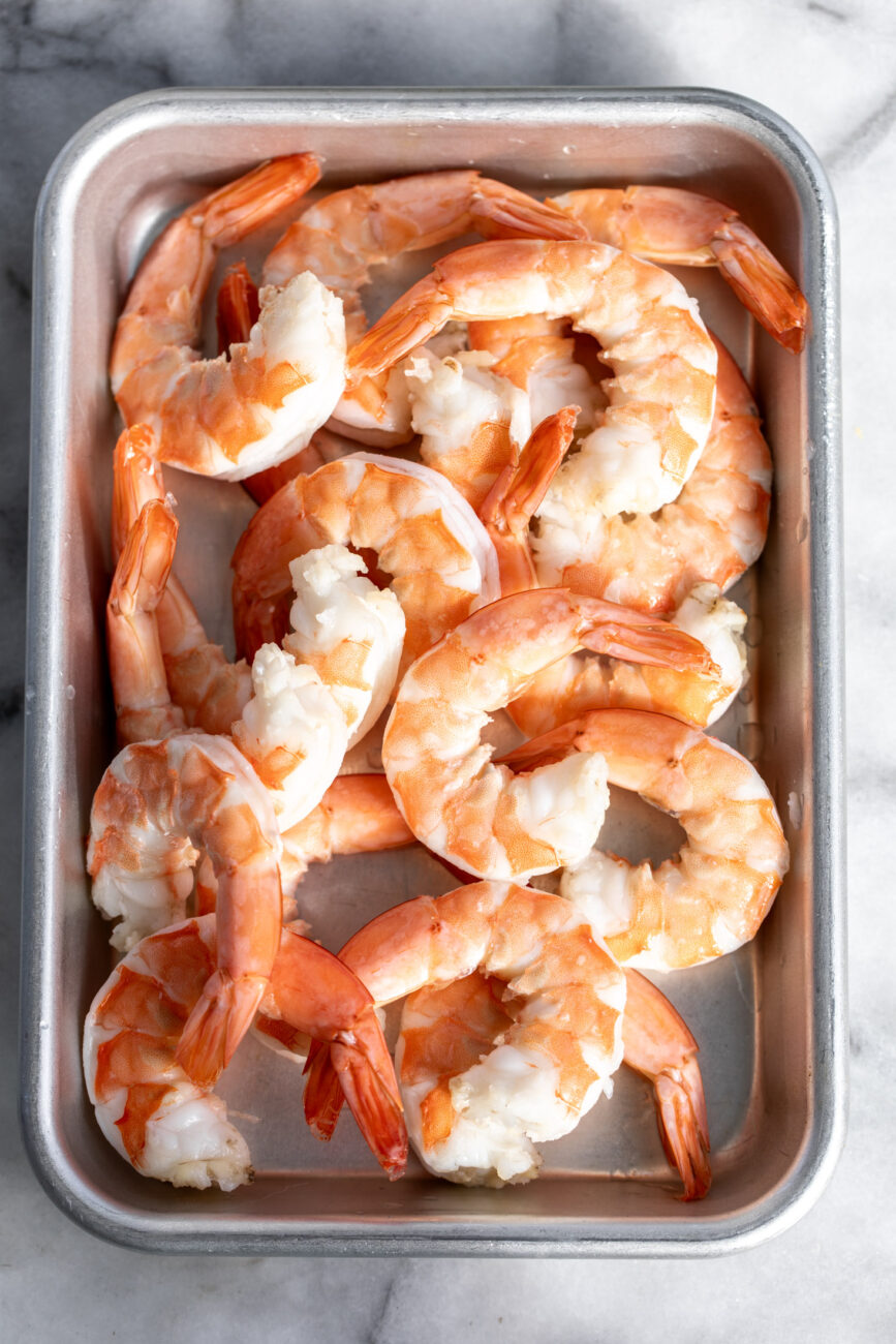 chilled peeled shrimp on baking sheet.