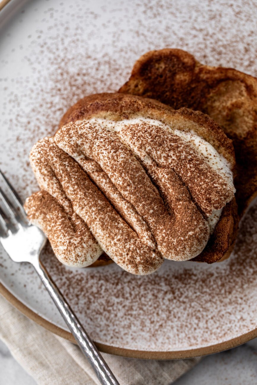 tiramisu french toast topped with mascarpone cream and cocoa powder.