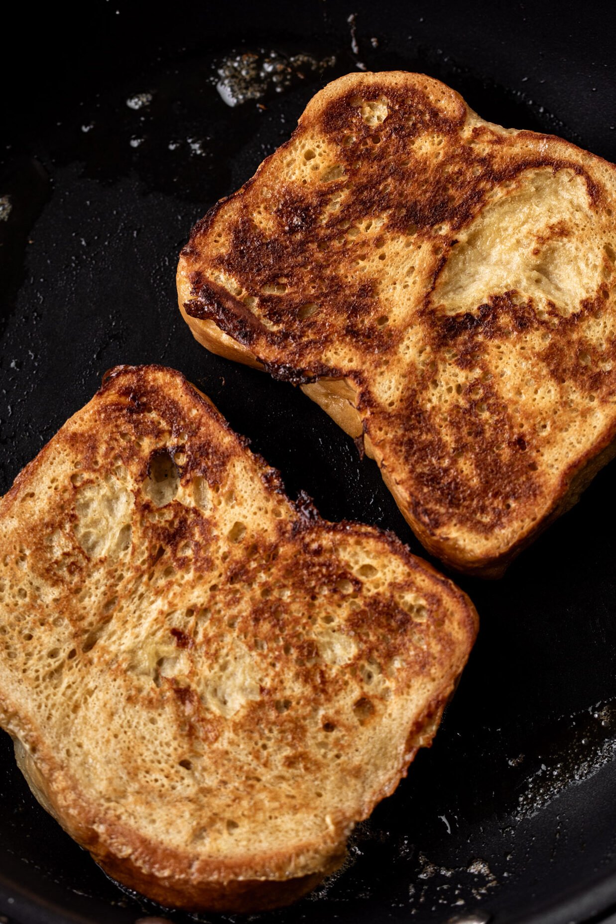 cooked French toast slices in nonstick pan.