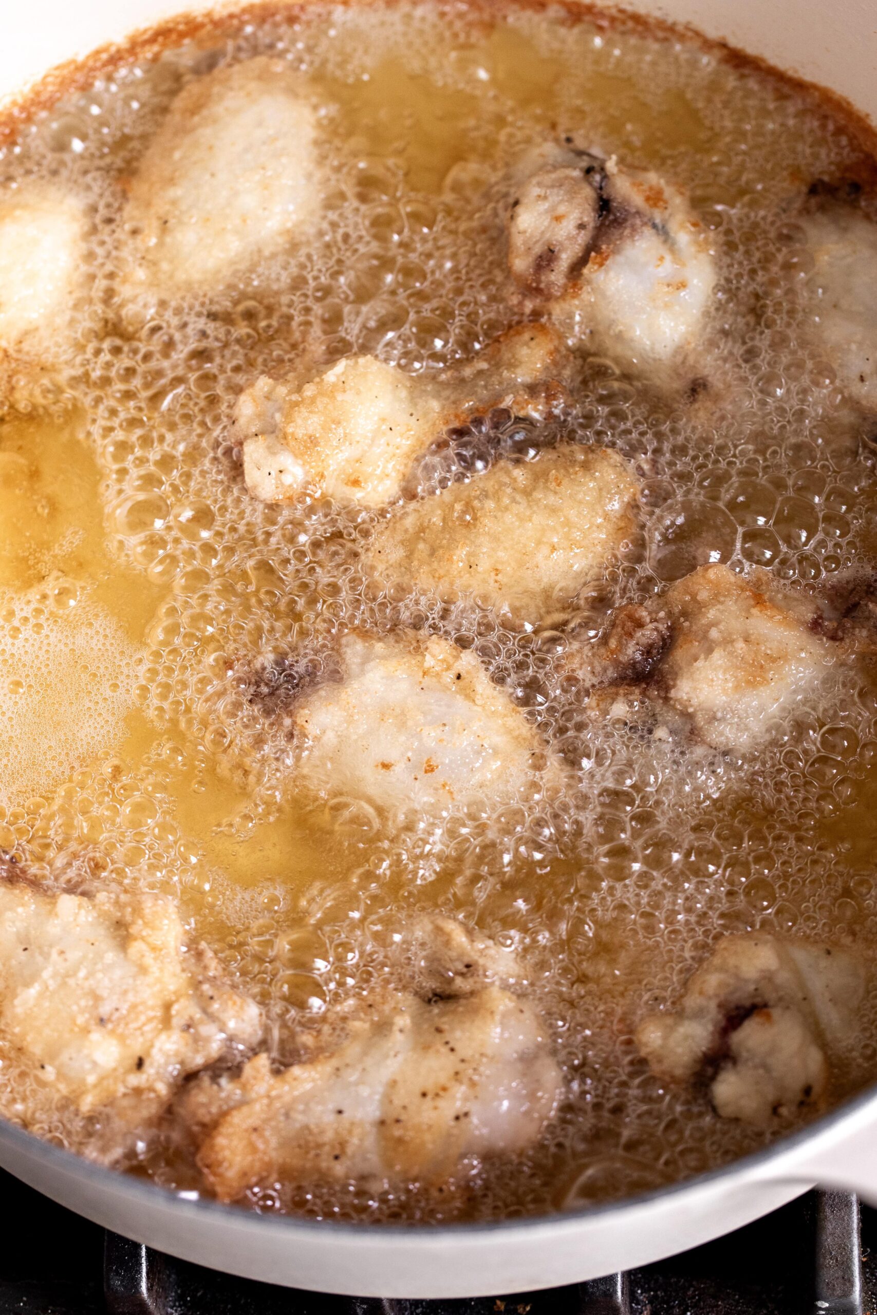 fried chicken wings in hot oil.