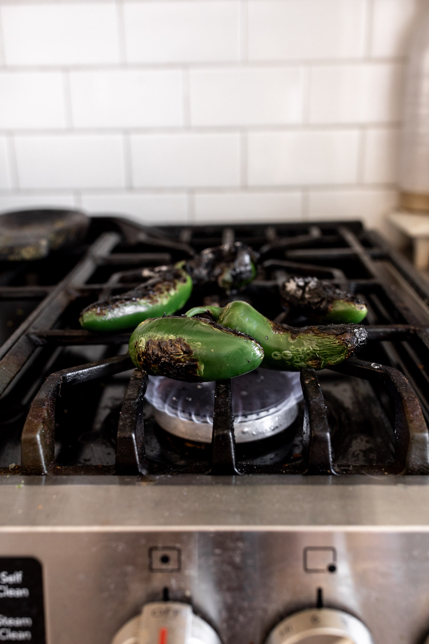 charred jalapeños on stove.