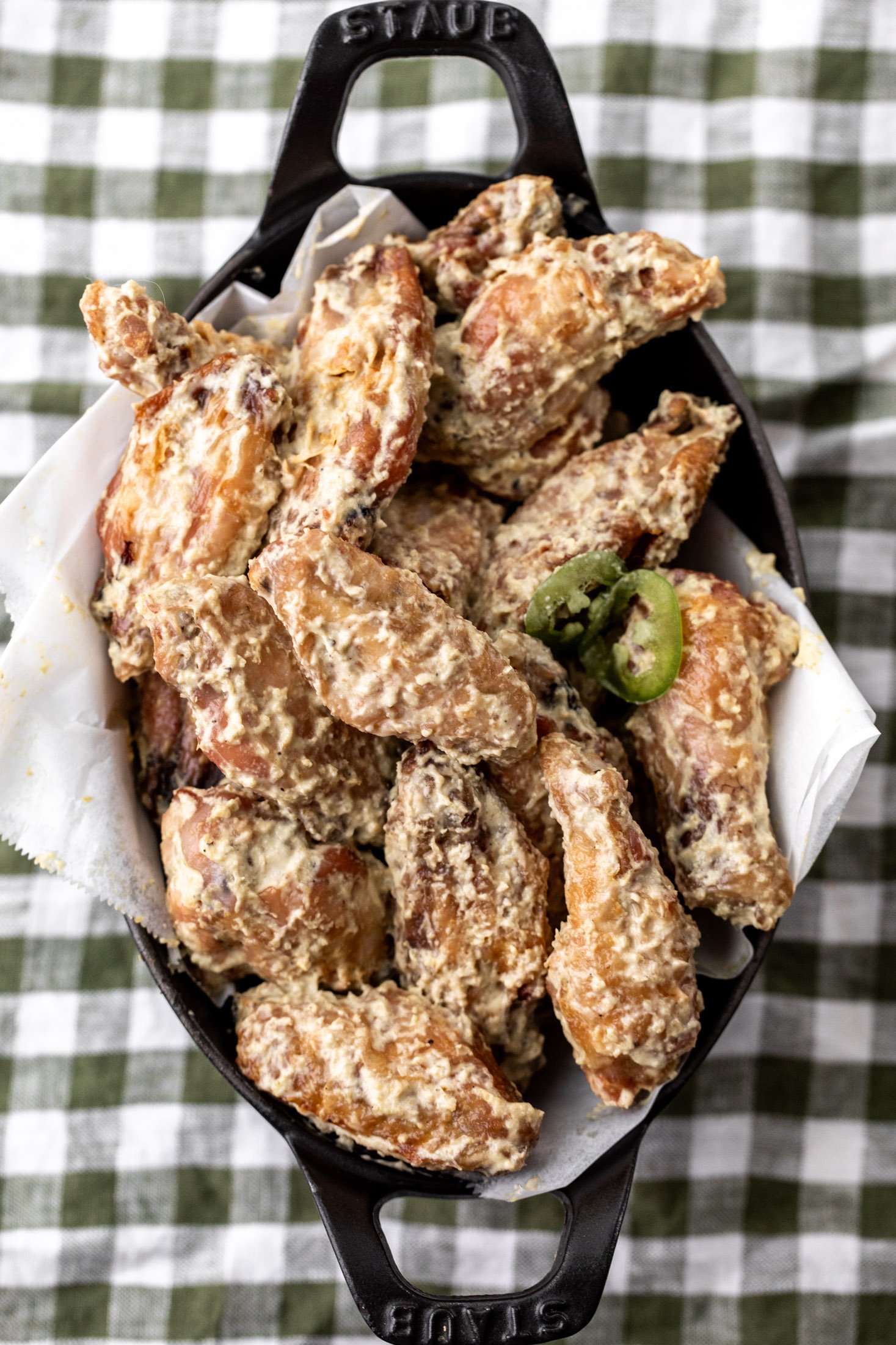 baked chicken wings with roasted jalapeño Alabama white sauce.