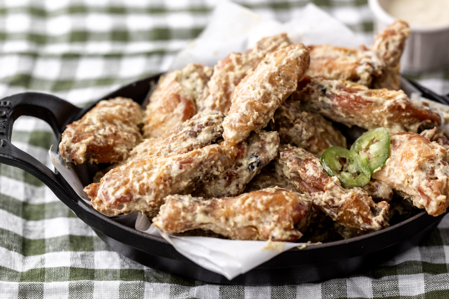 baked chicken wings with roasted jalapeño Alabama white sauce.