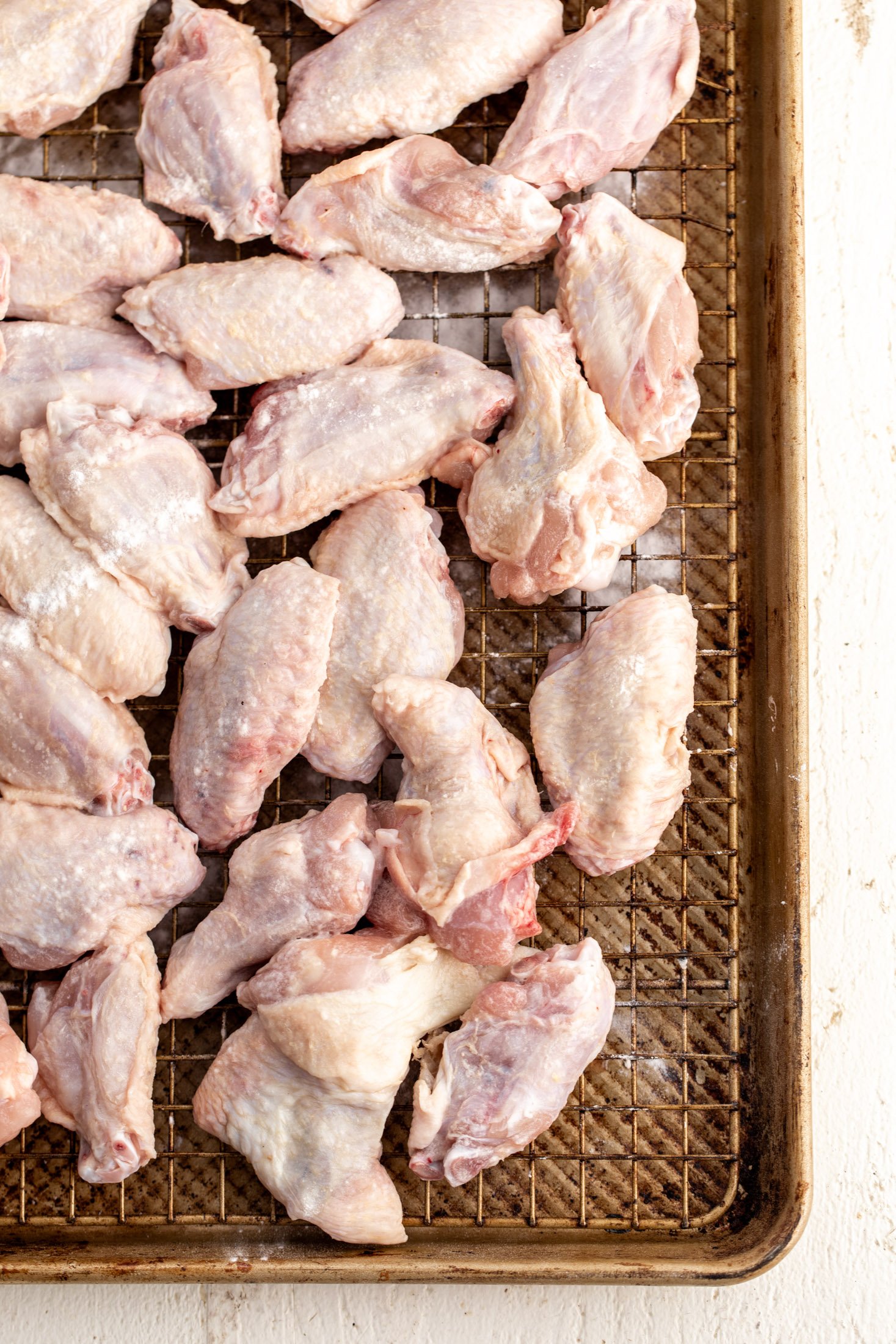 air dried chicken wings on baking rack with baking powder.