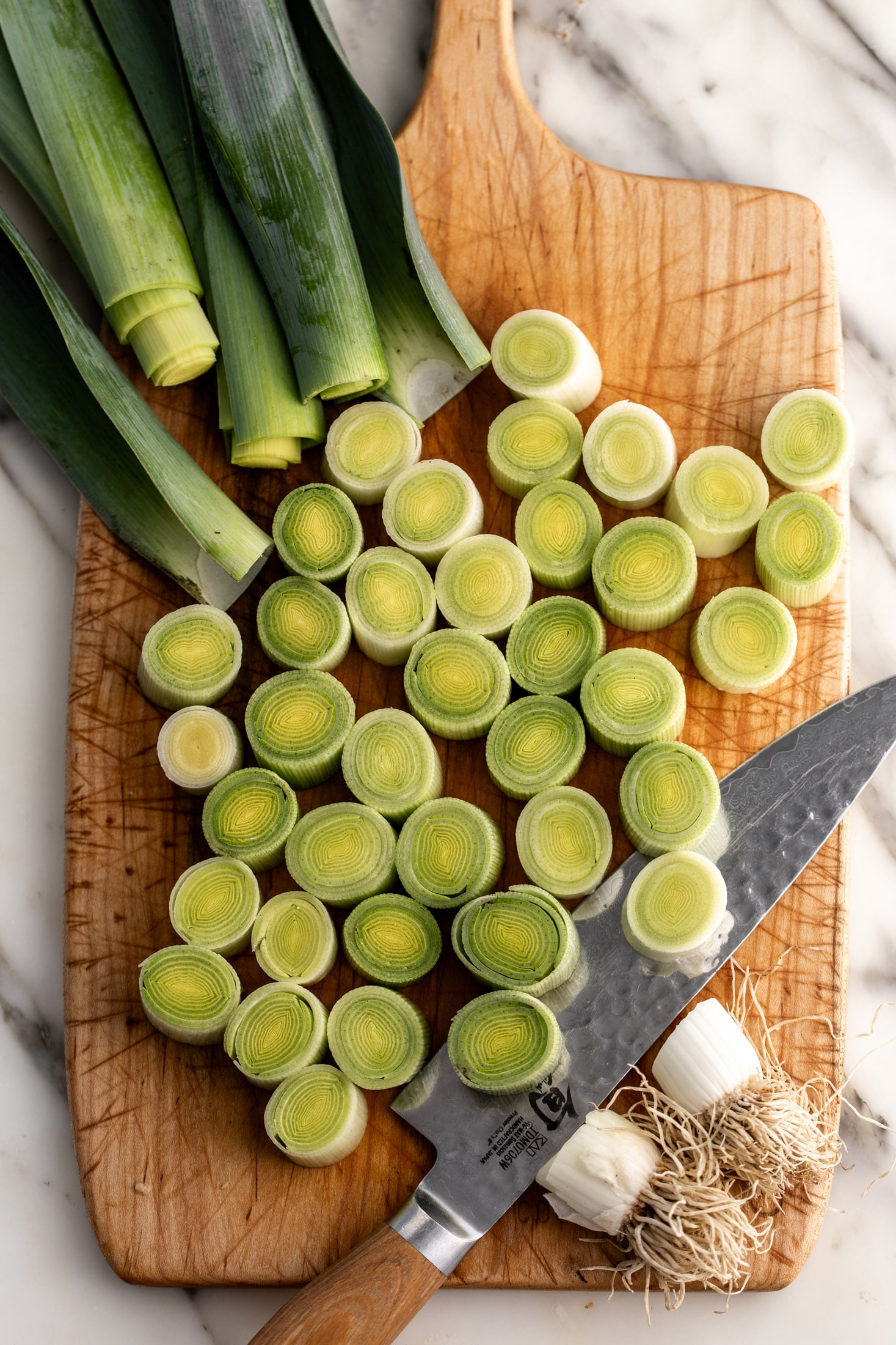 leeks cut into rounds on cutting board.