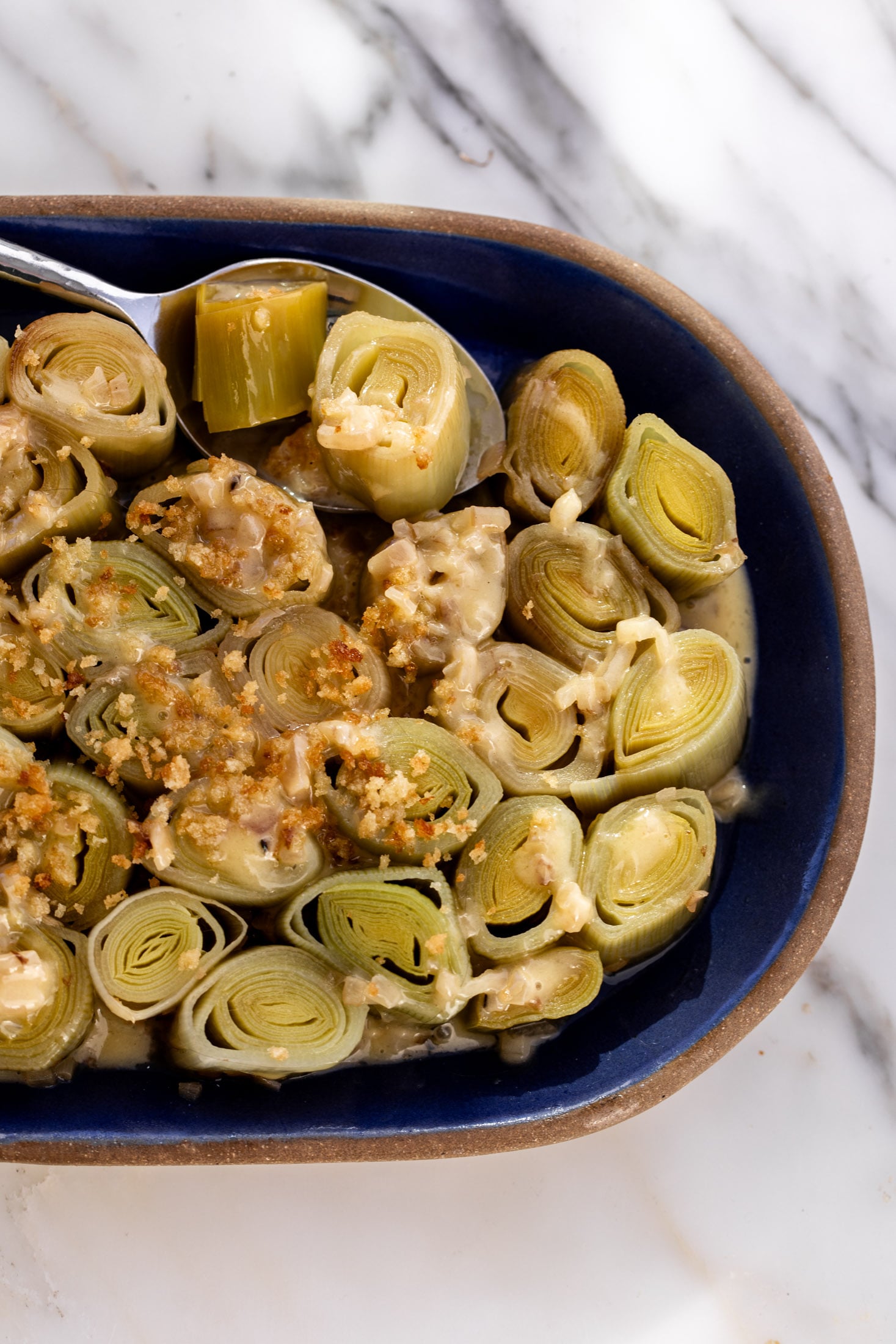 white wine-braised leeks with crispy buttered breadcrumbs.