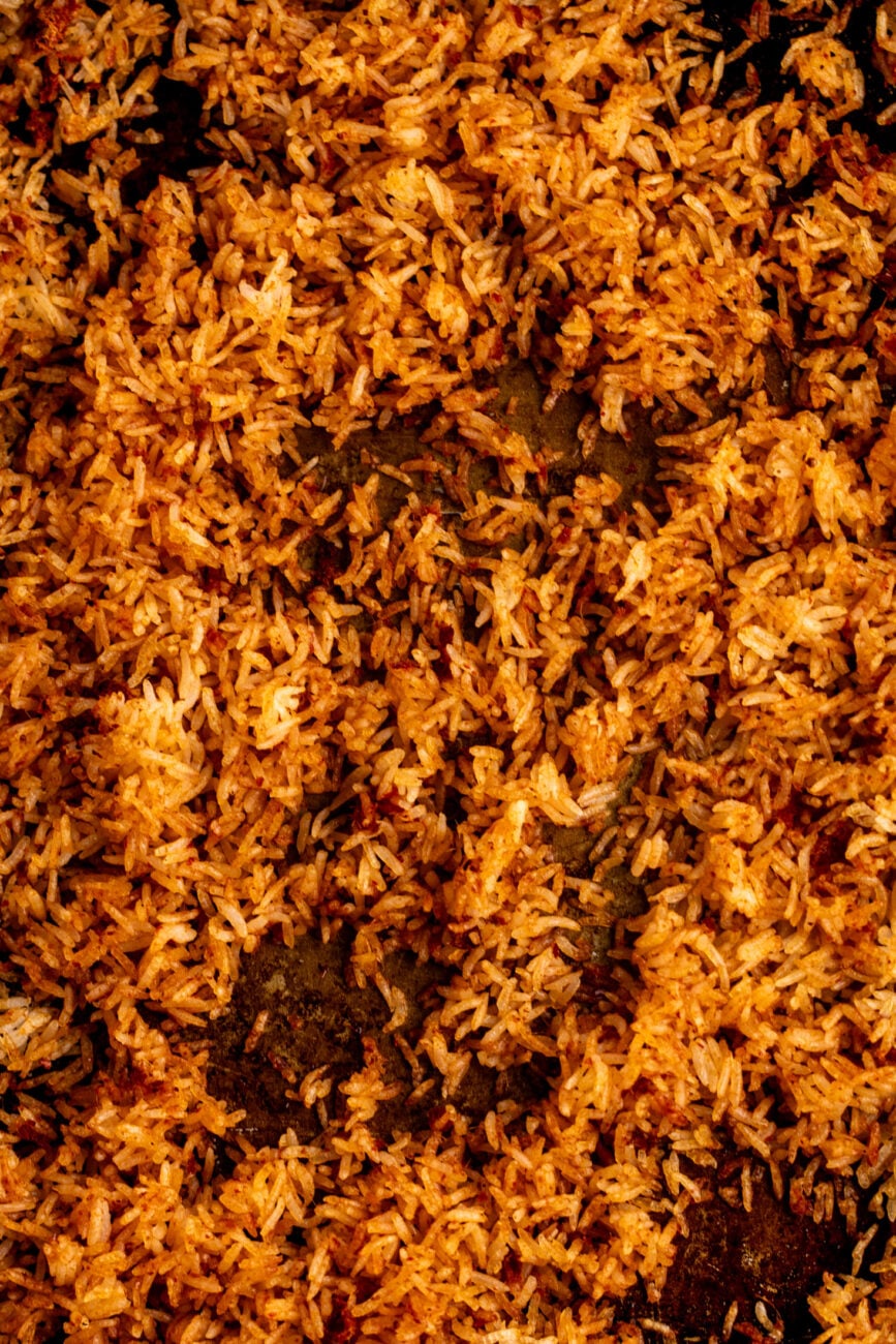 baked crispy rice on a sheet pan tossed with curry paste and oil.