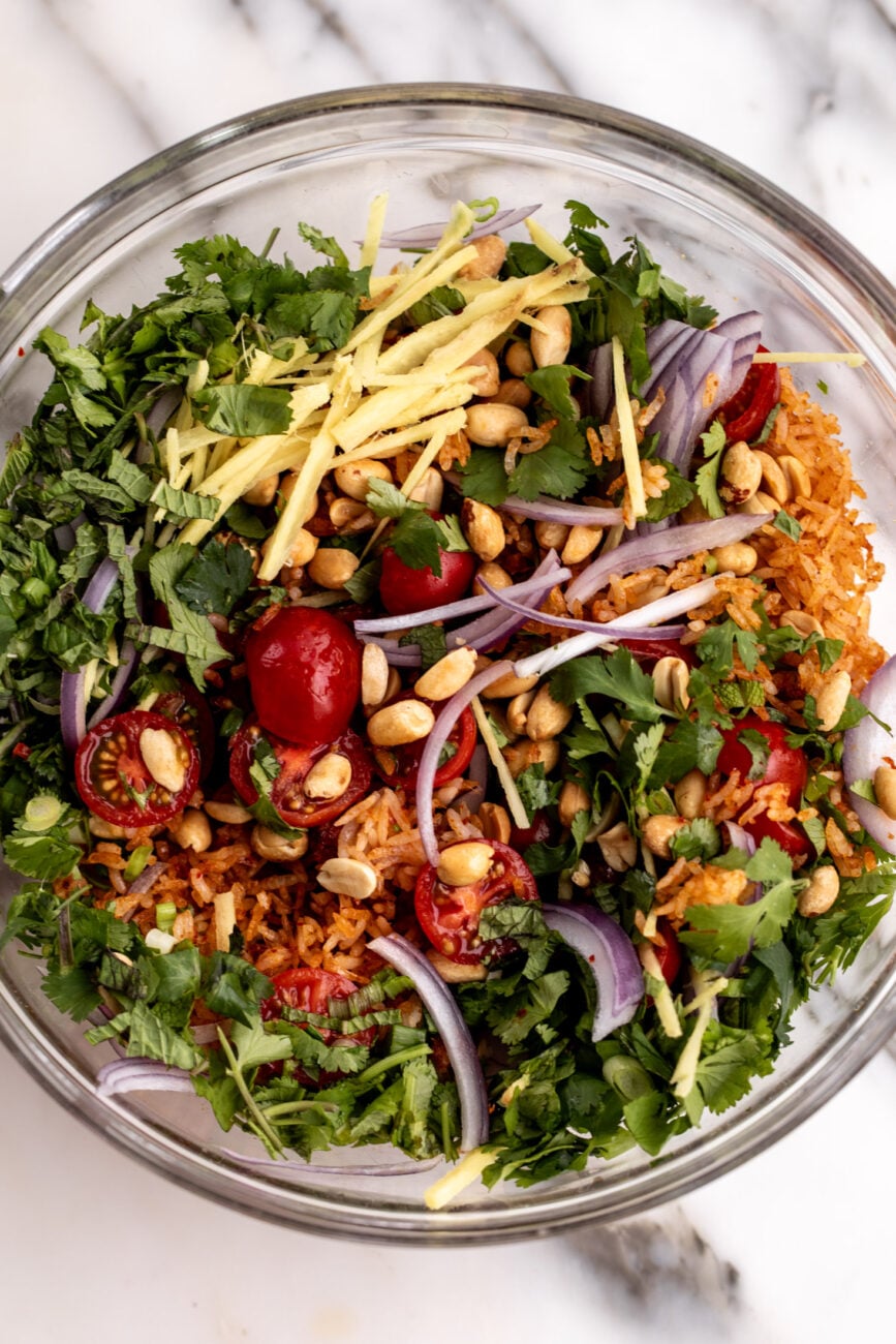 Thai baked crispy rice salad ingredients combined in mixing bowl.
