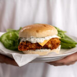 homemade filet o fish sandwich with butter lettuce salad.