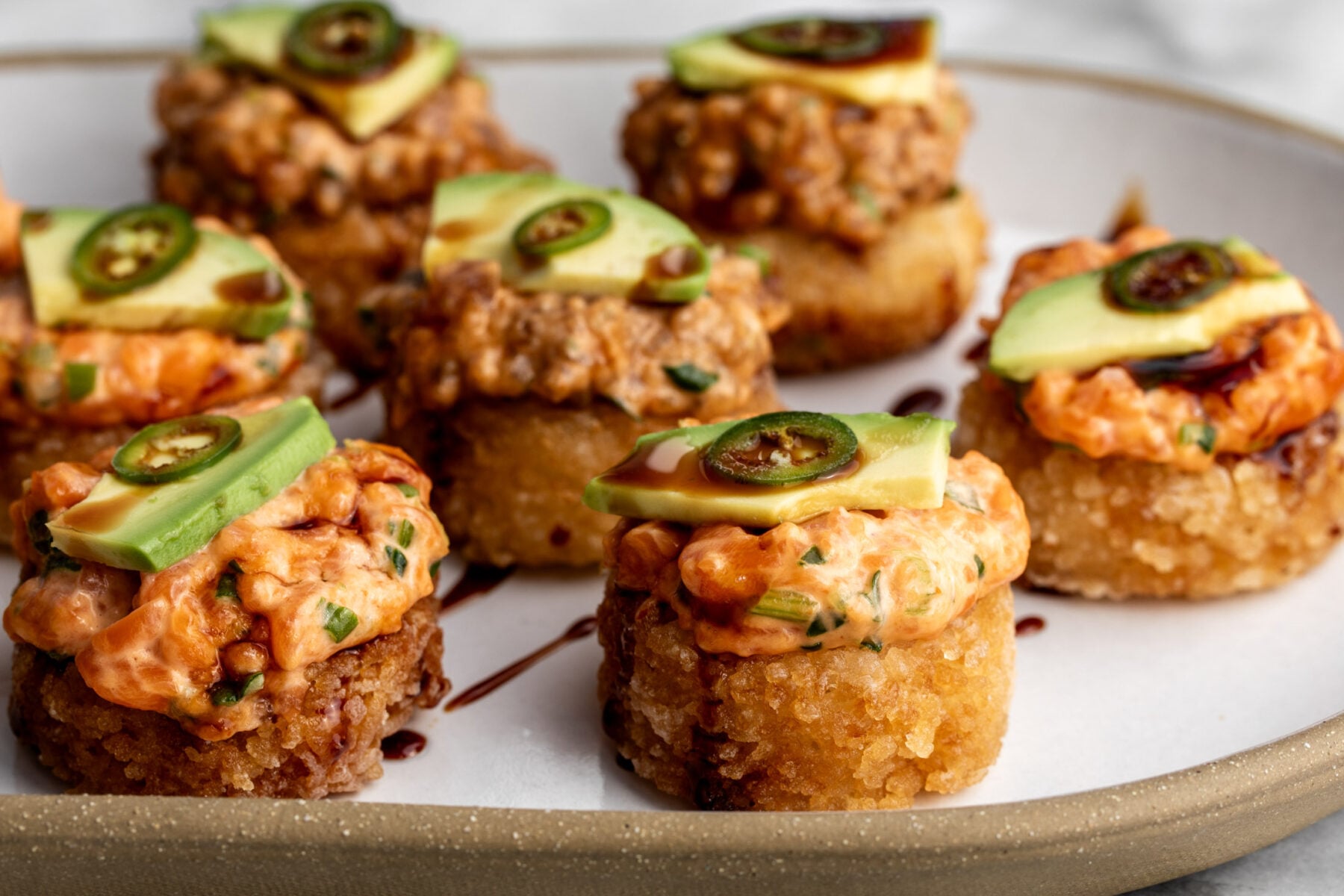 how to make crispy rice the nobu method topped with spicy tuna and salmon with avocado.