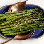 roasted miso butter asparagus on blue platter.