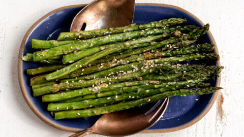roasted miso butter asparagus on blue platter.