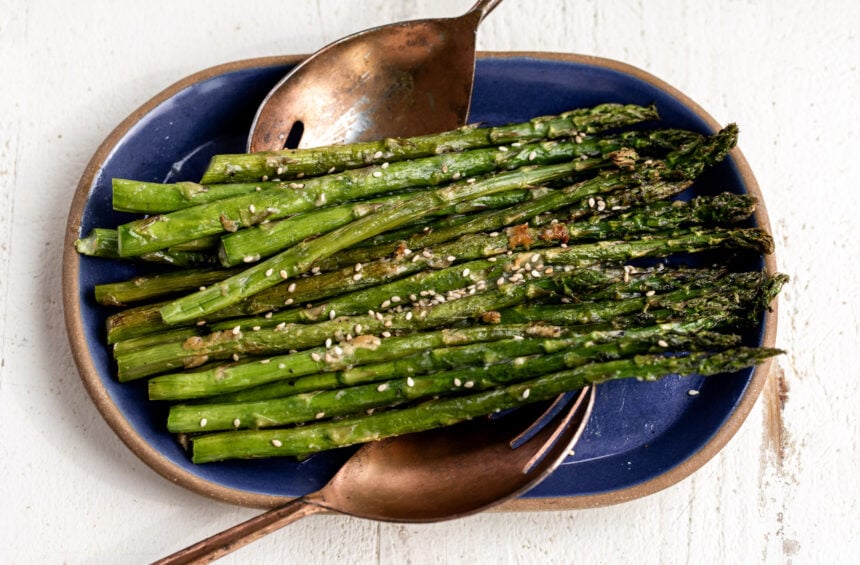 roasted miso butter asparagus on blue platter.