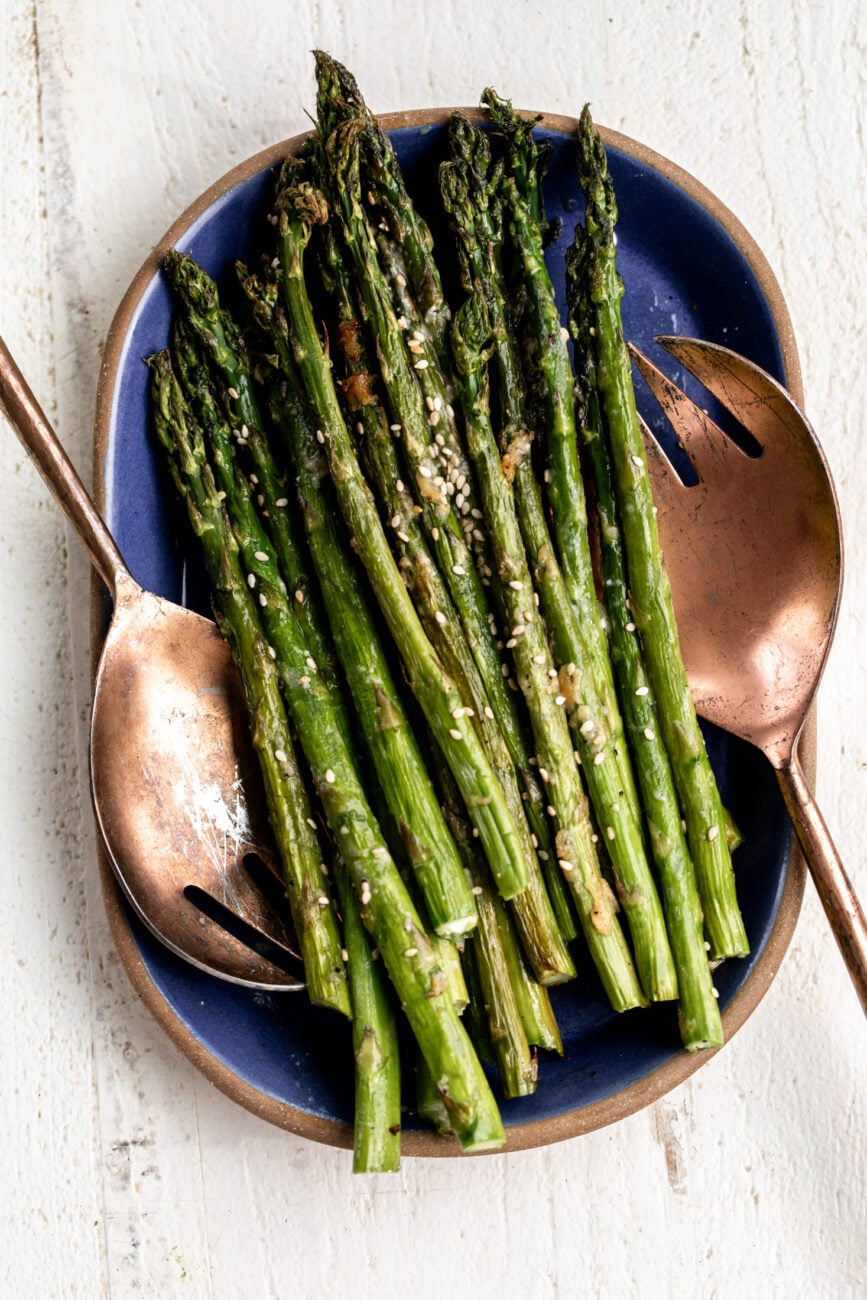 roasted miso butter asparagus on blue platter.