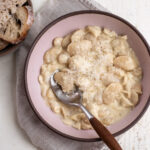 10 minute alfredo butter beans in bowl with side of bread.
