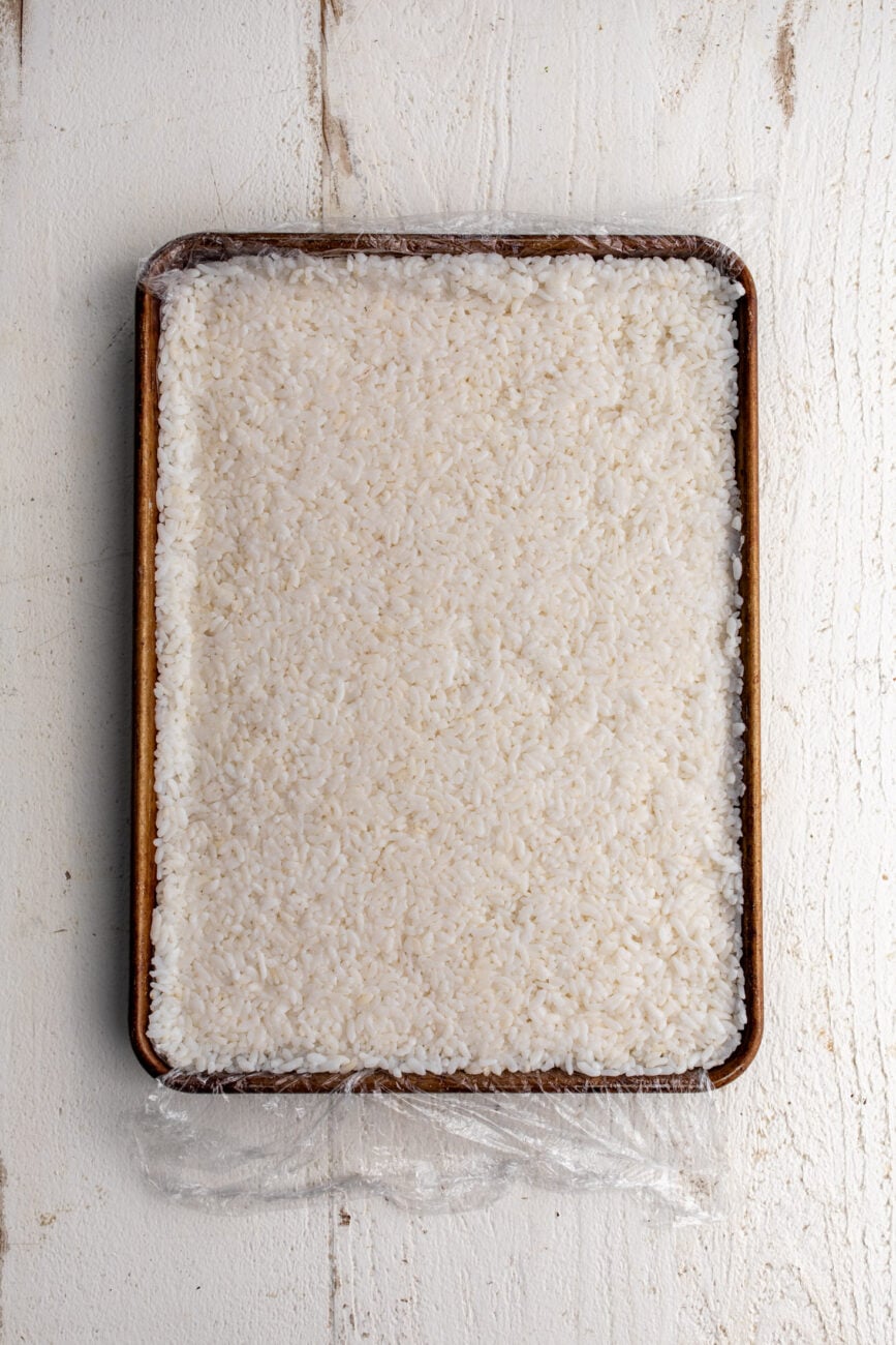 press the rice into a sheet pan to mold.