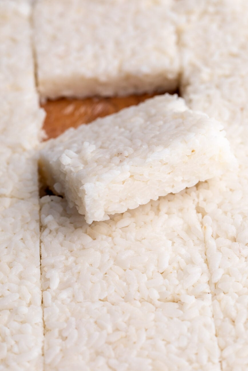 cut squares of pressed sushi rice.