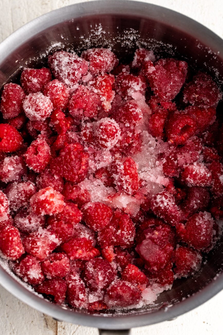 macerated raspberries in sugar for jam.