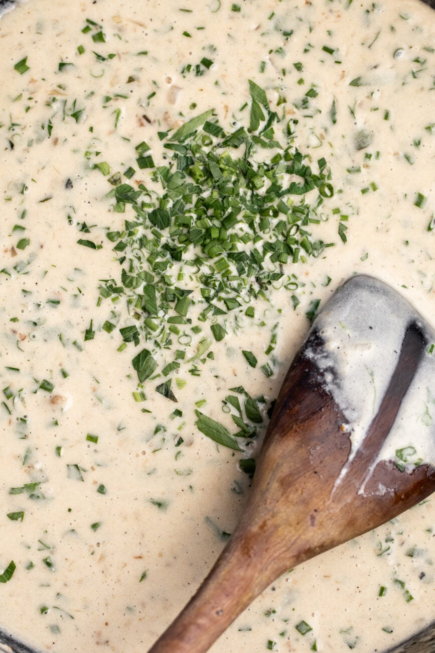 creamy herb pan sauce reduced with wooden spoon.