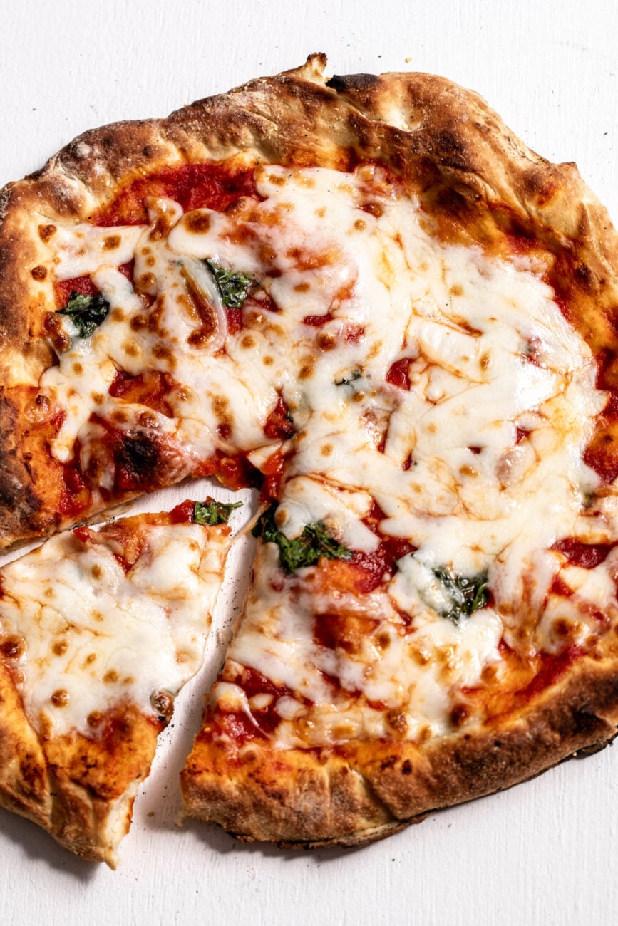 4-step easy homemade cheese pizza with slice cut out.