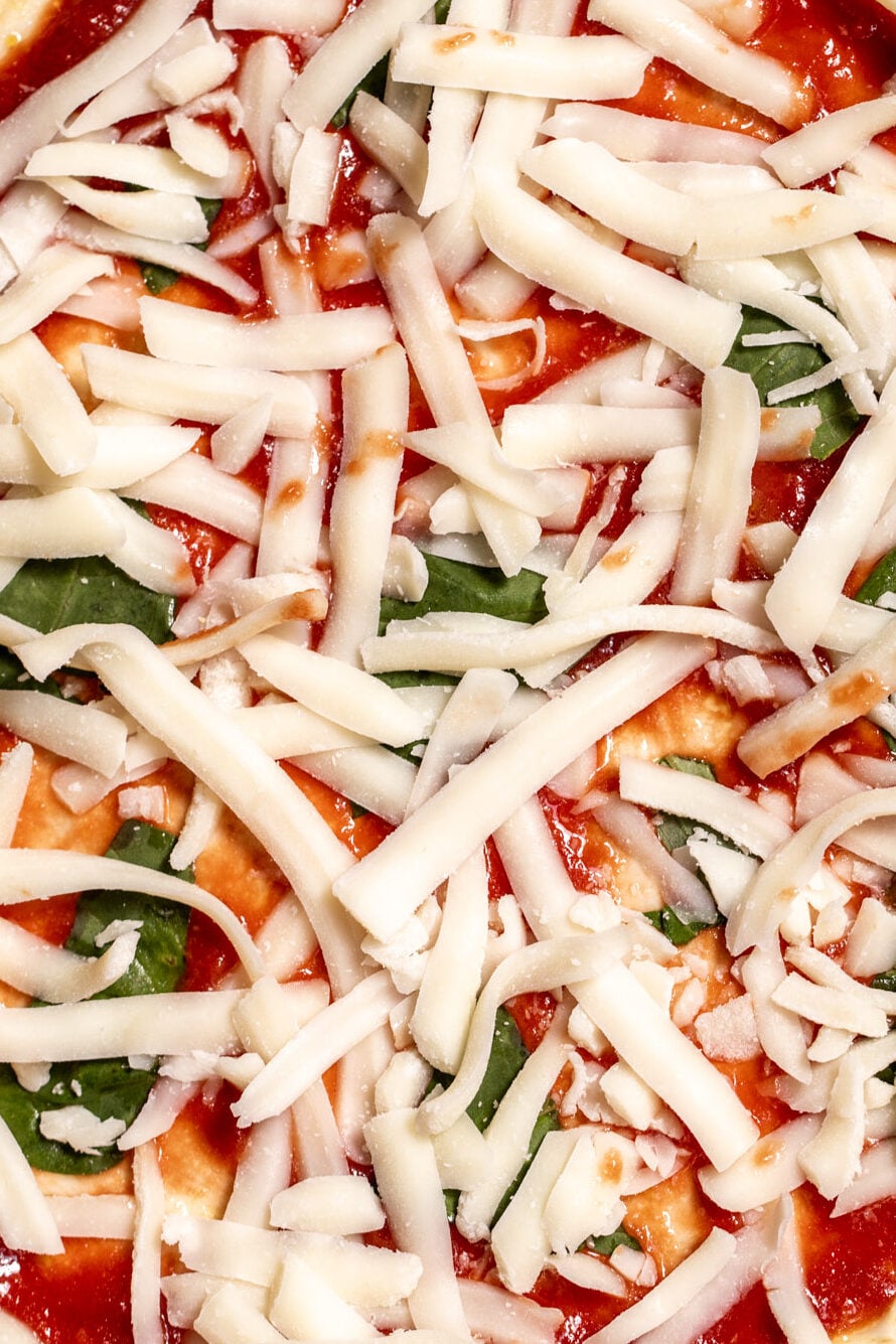 pizza toppings on pizza crust.