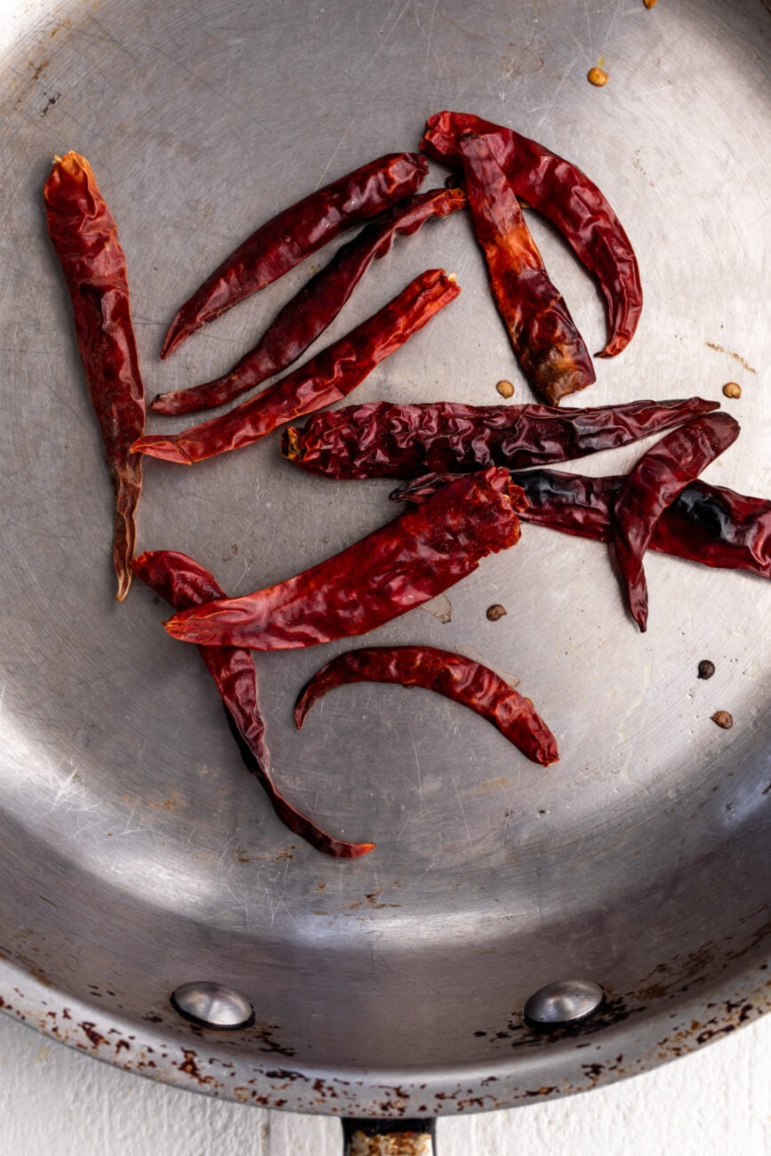 dry toasted chiles de arbol in sauté pan.