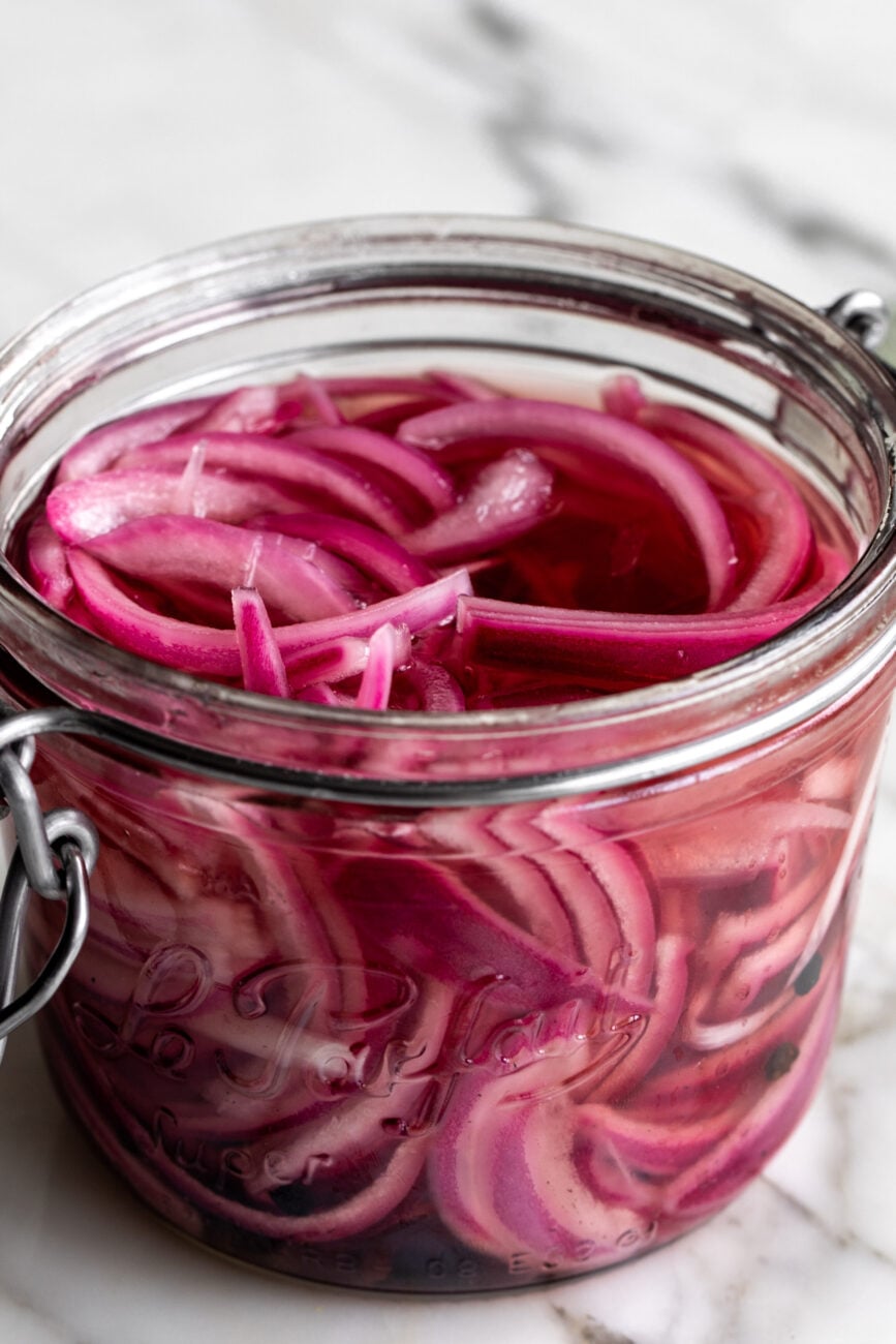 quick pickled onions in glass mason jar.