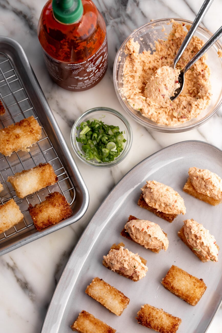 how to assemble dynamite lobster crispy rice with sriracha and green onion. 