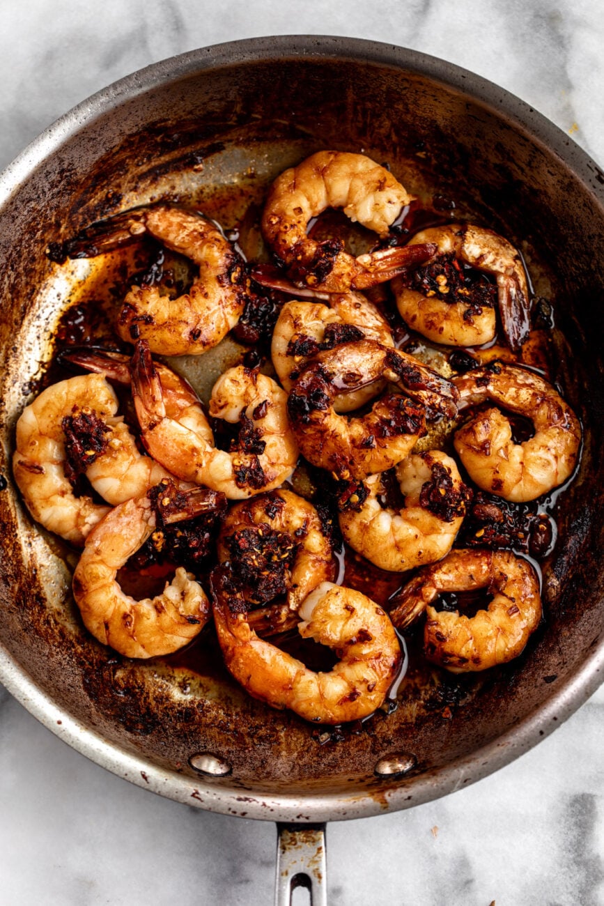 honey garlic chili crisp shrimp in pan.