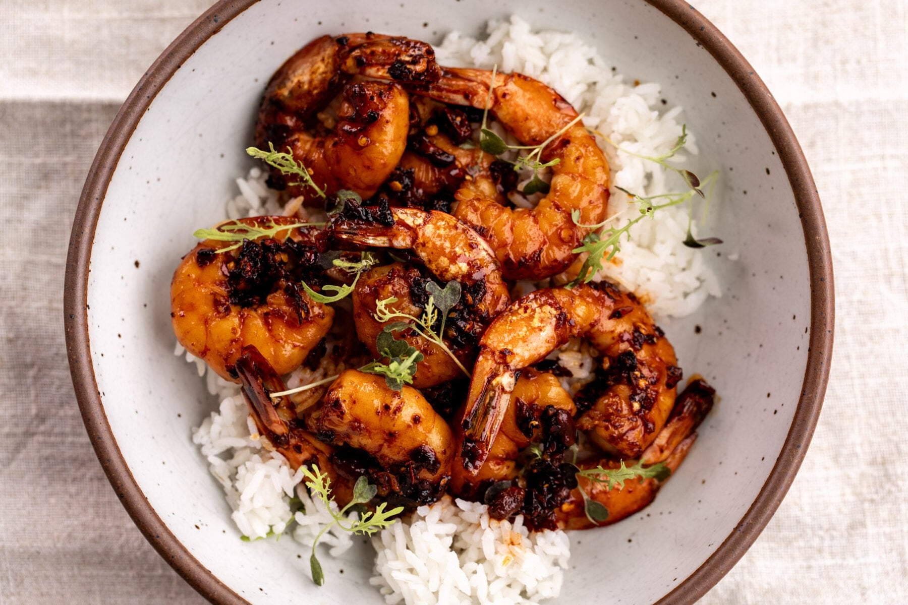 honey garlic chili crisp shrimp over white rice.