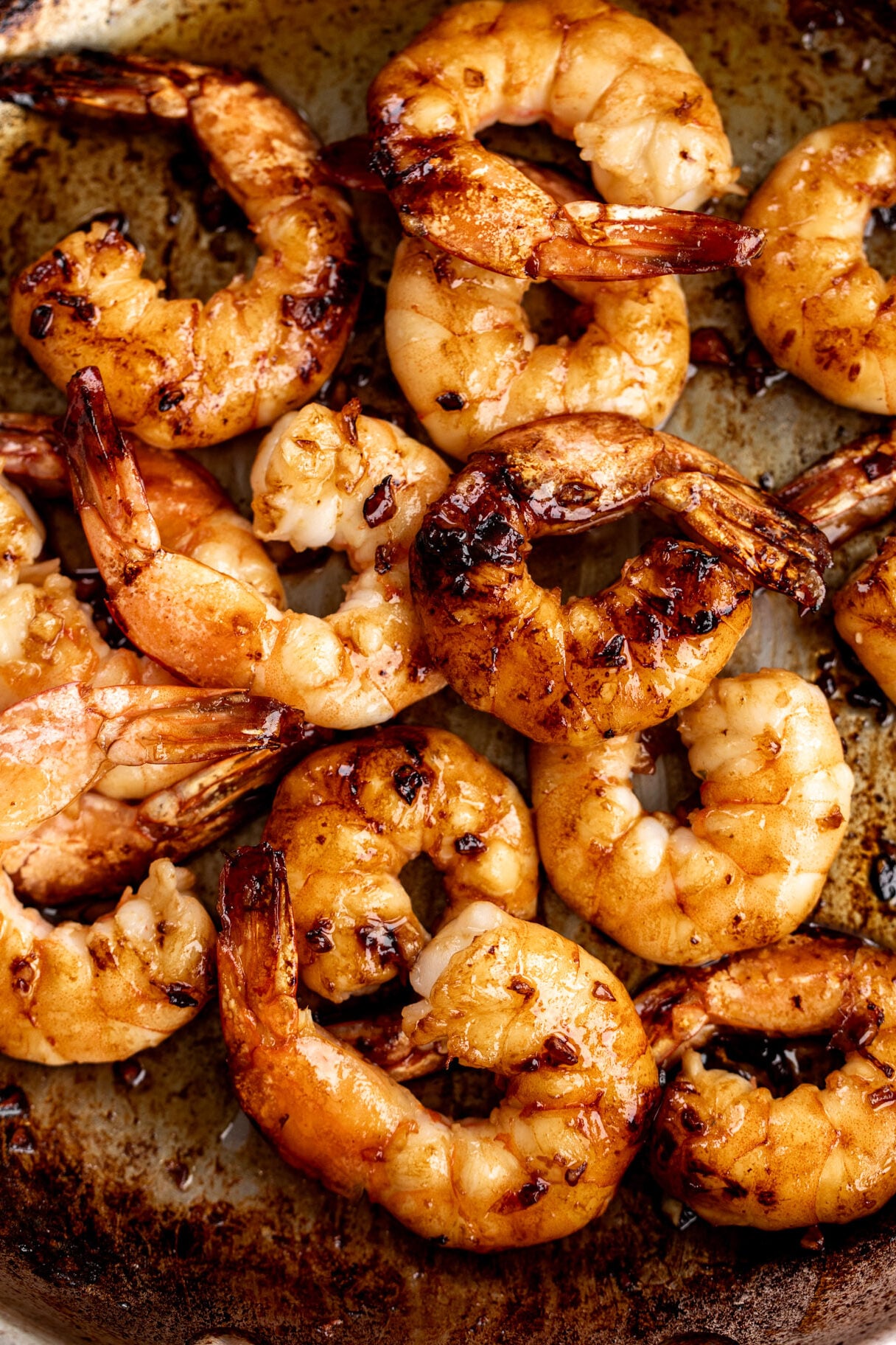 sautéed honey garlic shrimp in sauté pan.