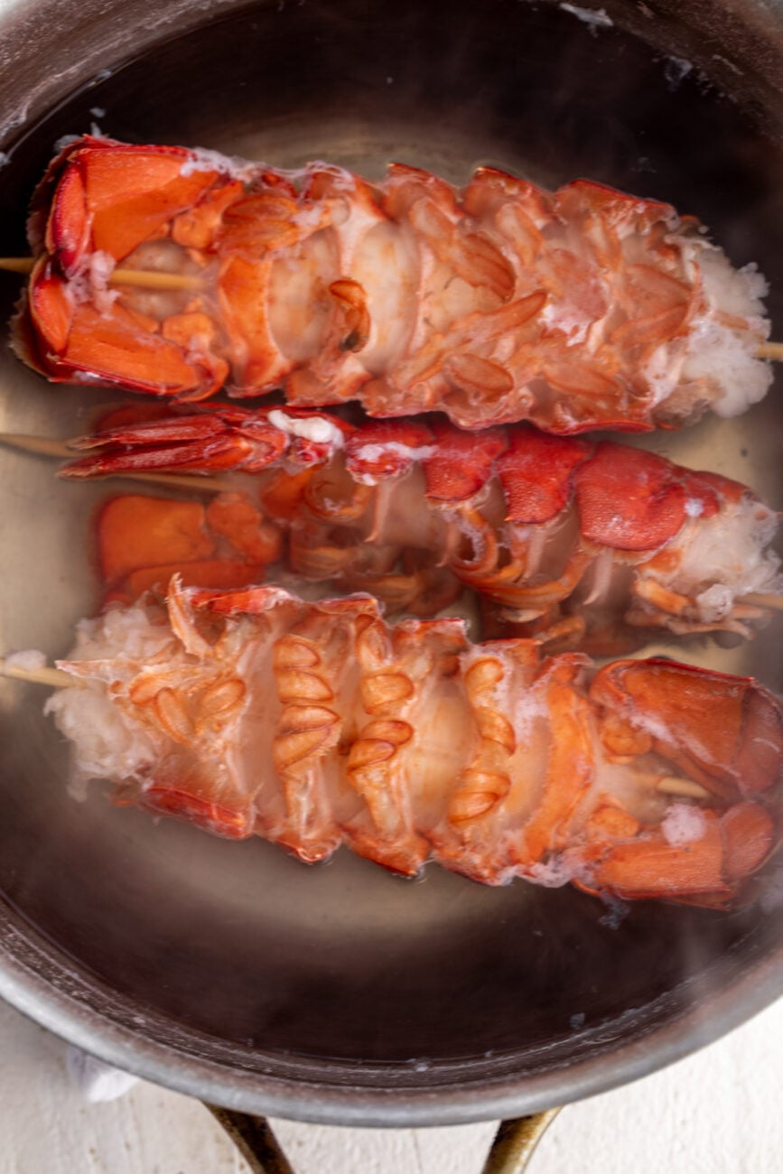 boiled lobster tails in pot of water.