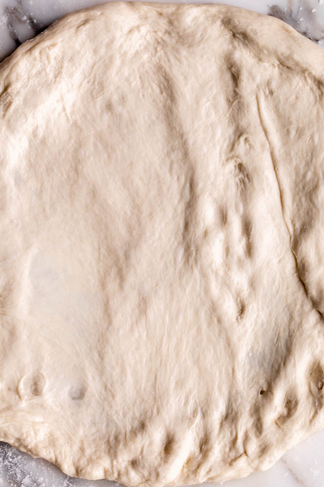 pressed out pizza dough ready for toppings.
