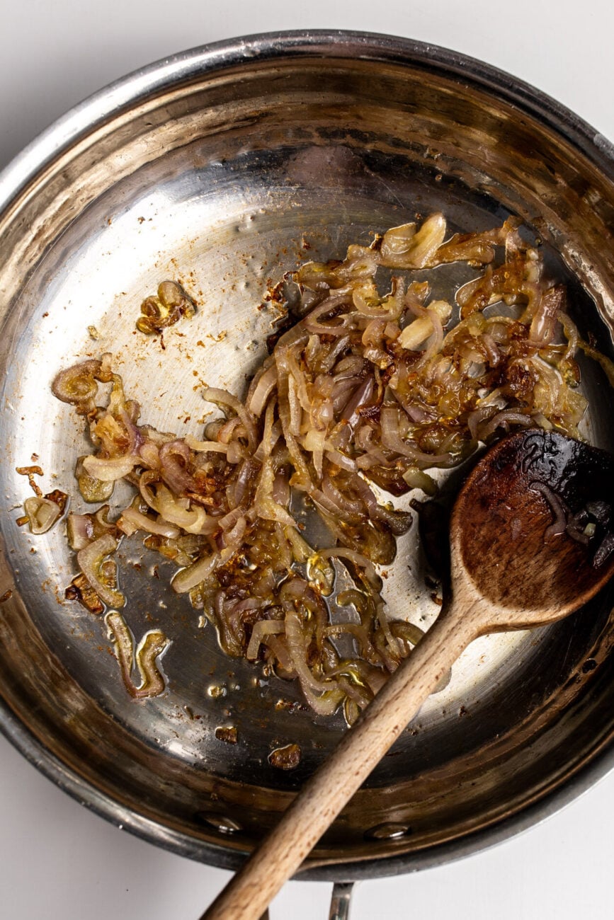 Caramelized shallots in a pan.