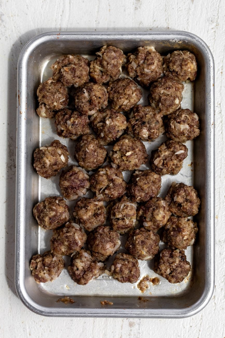 baked mini meatballs cooked on baking sheet browned.